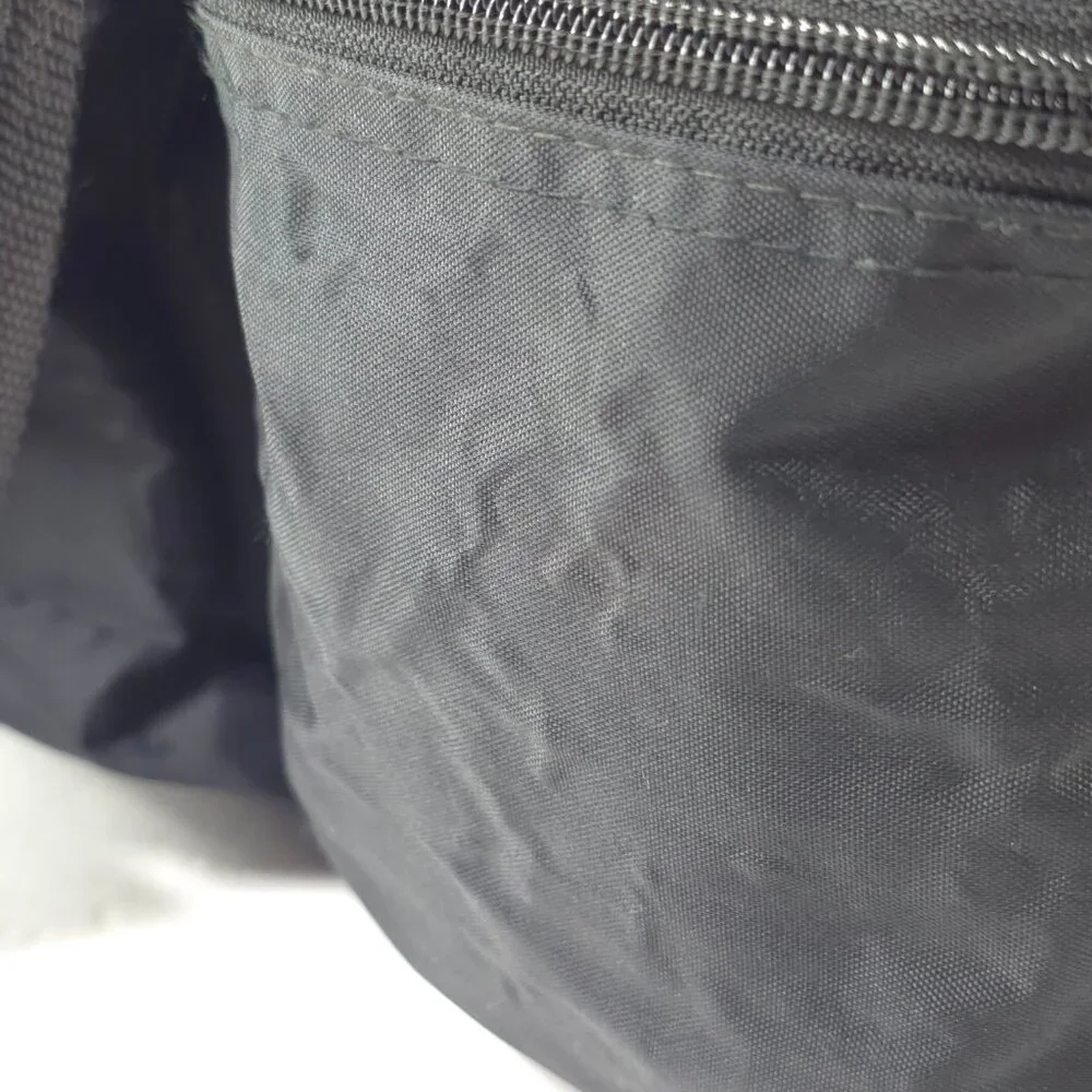 VINTAGE HARLEY DAVIDSON AN AMERICAN LEGEND BLACK DUFFLE BAG WITH SHOULDER STRAP.